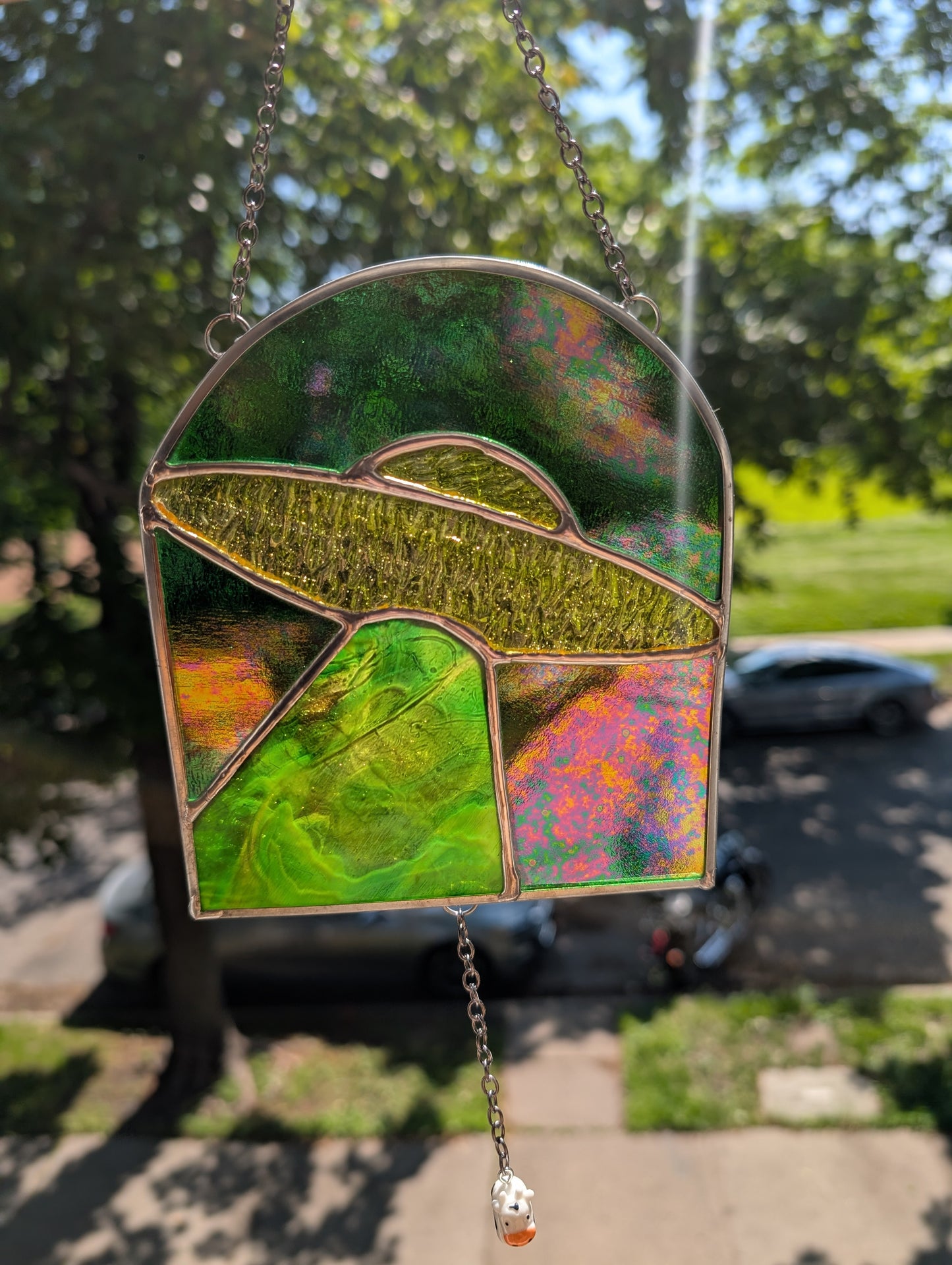 Handcrafted stained glass UFO beaming up a cow yellow and green