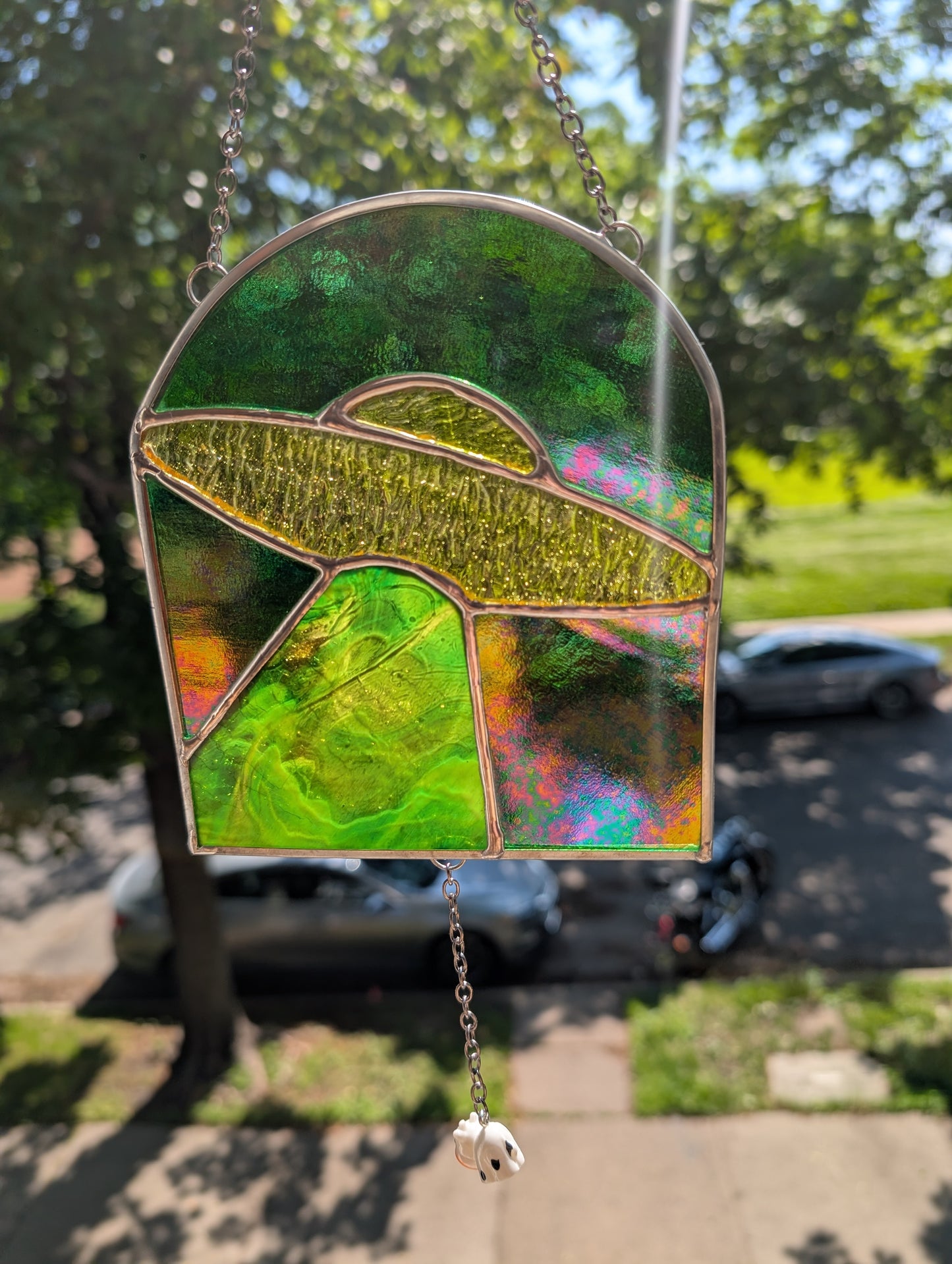 Handcrafted stained glass UFO beaming up a cow yellow and green